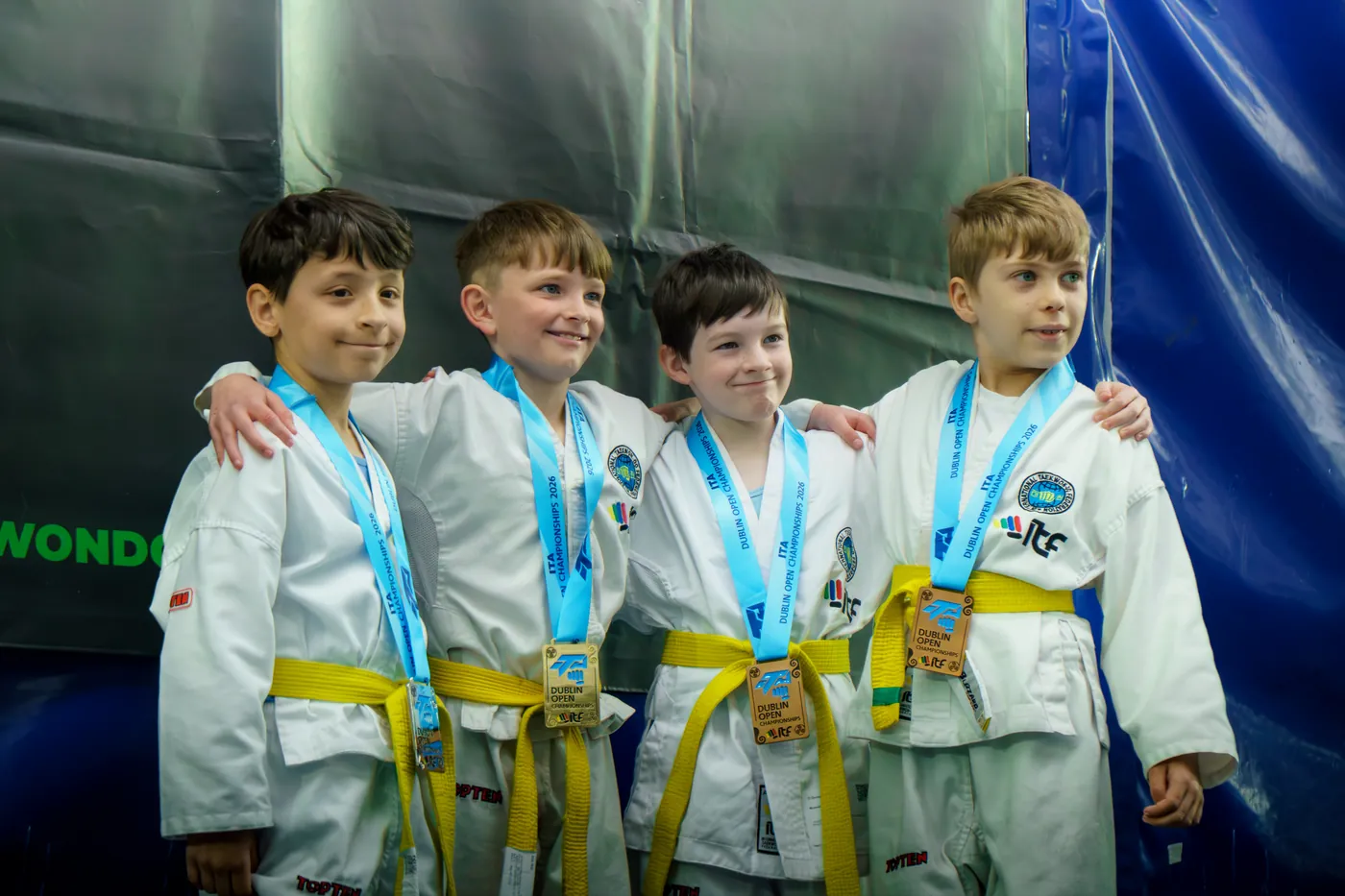 Junior team members standing together with their medals