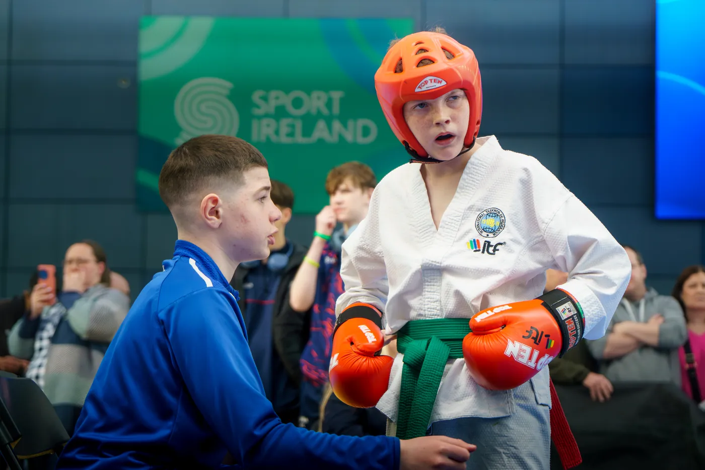 Junior competitor in headguard and gloves preparing to spar
