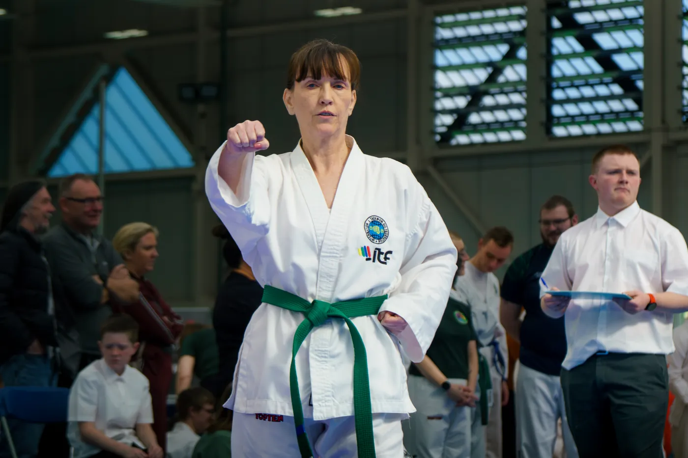 Adult member performing a pattern in front of the judging panel